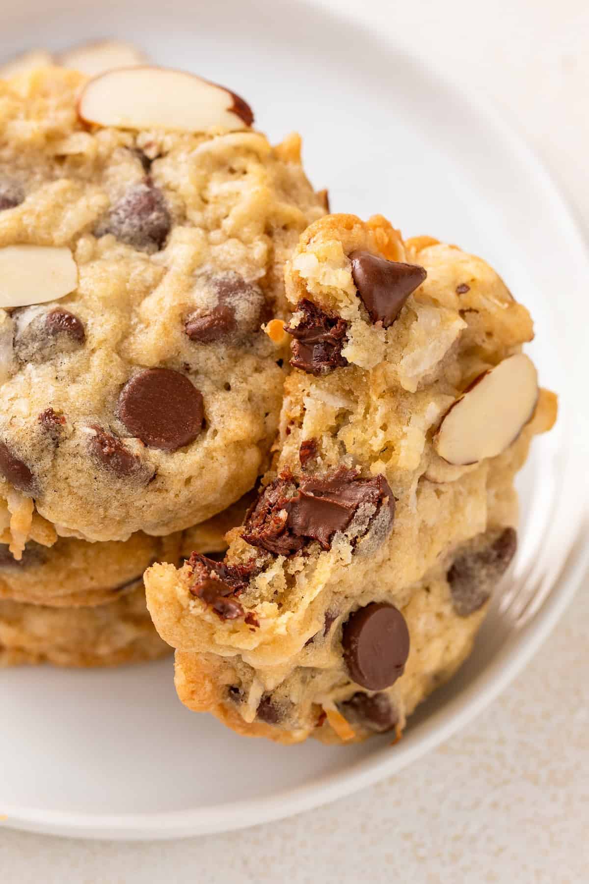 These easy-to-make Almond Joy Cookies are just like the candy bar with a chewy, chocolatey, and nutty bite that's loaded with coconut flavor! Chewy almond joy cookies are placed on a white plate.