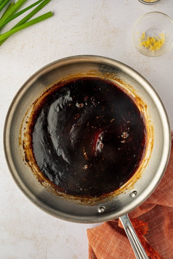 These sweet and savory Asian Chicken Meatballs are infused with fresh ginger and garlic, then baked and coated in a sticky honey-soy glaze. Asian sauce mixed in a saucepan.