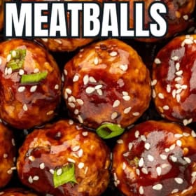 Easy asian chicken meatballs garnished with sesame seeds and green onions.