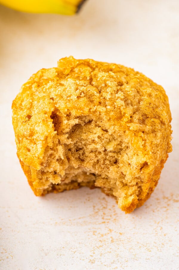 Made in one-bowl in just 25 minutes, these easy Brown Sugar Banana Muffins are extra moist with a caramelized brown sugar crunchy topping! Bitten-into brown sugar banana muffin.
