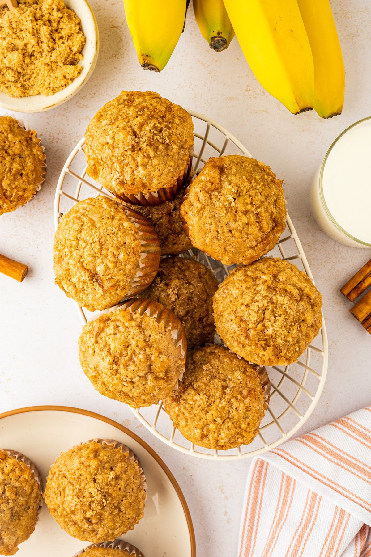 Made in one-bowl in just 25 minutes, these easy Brown Sugar Banana Muffins are extra moist with a caramelized brown sugar crunchy topping! Small wire basket filled with moist banana muffins with a brown sugar topping.