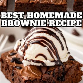 Chewy, fudge-y brownies with ice cream served on a white plate.