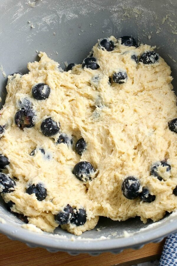These Blueberry Scones are soft, flaky and bursting with blueberries. Add a creamy vanilla glaze and this easy scone recipe is a real treat! Fluffy blueberry scone dough in a bowl.