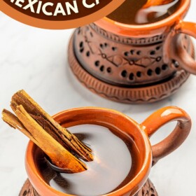 Two glass of Café de Olla with cinnamon sticks.