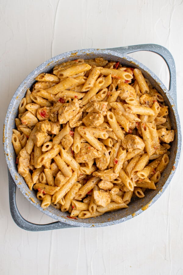 This flavorful and creamy Cajun Chicken Pasta recipe is one of our favorite restaurant style dishes to make at home in just 30 minutes! Creamy Cajun sauce being tossed together with chicken and tender pasta.