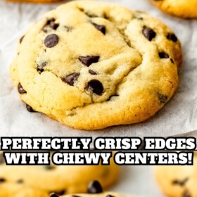 Chocolate chip cookies on a cookie sheet with parchment paper and a bite taken out of a cookie.
