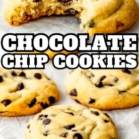 Chocolate chip cookies cooling on parchment paper and a bite taken out of one cookie.