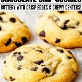 Chocolate chip cookies on a parchment paper covered cooling rack.