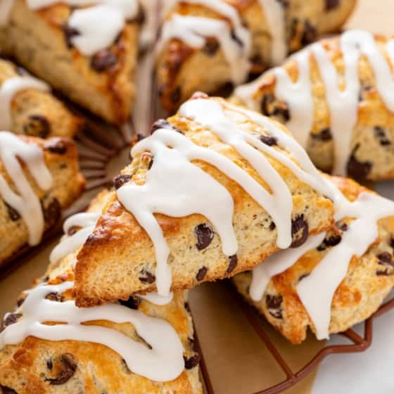 Chocolate chip scones with sweet icing on top are presented in a small circle.
