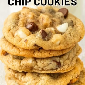 A stack of chewy cookies filled with chocolate chips and walnuts is shown close up.
