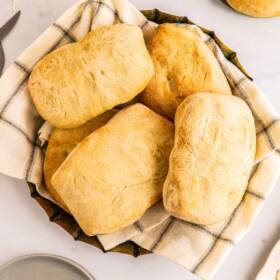 Rolls in a dish lined with a clean cloth napkin.