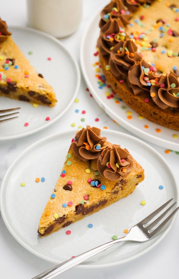 Chocolate frosting piped on a big chocolate chip cookie.