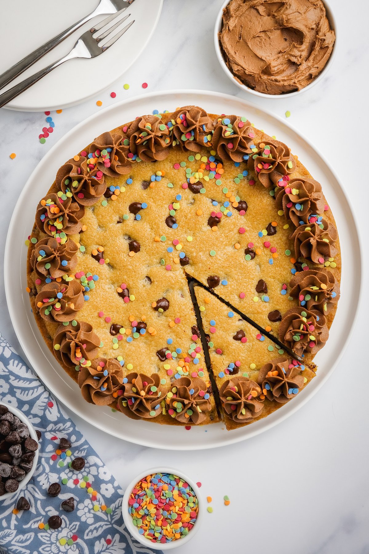 Big chocolate chip cookie with chocolate buttercream frosting.