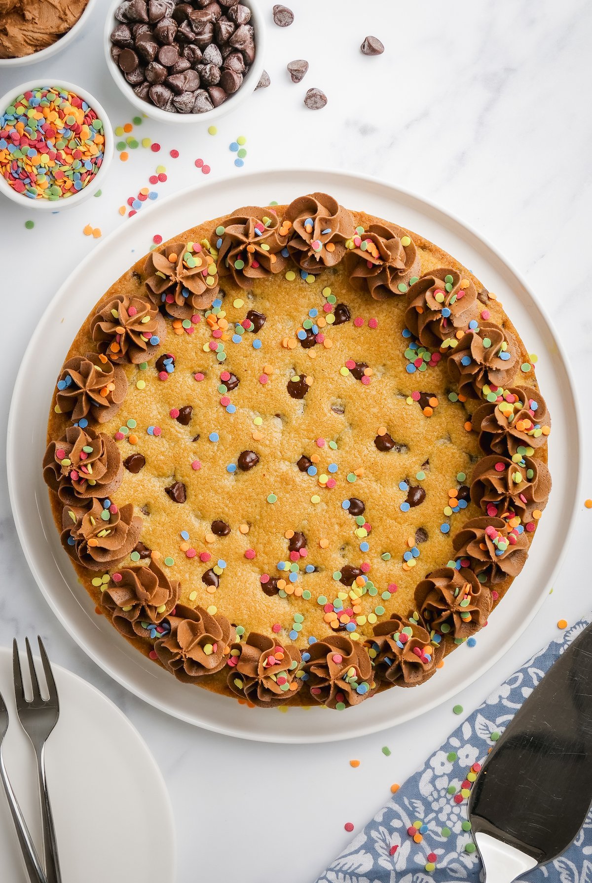 Baked cookie with chocolate buttercream and sprinkles.