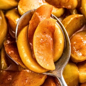 A spoonful of Cracker Barrel fried apples in a sweet cinnamon syrup.