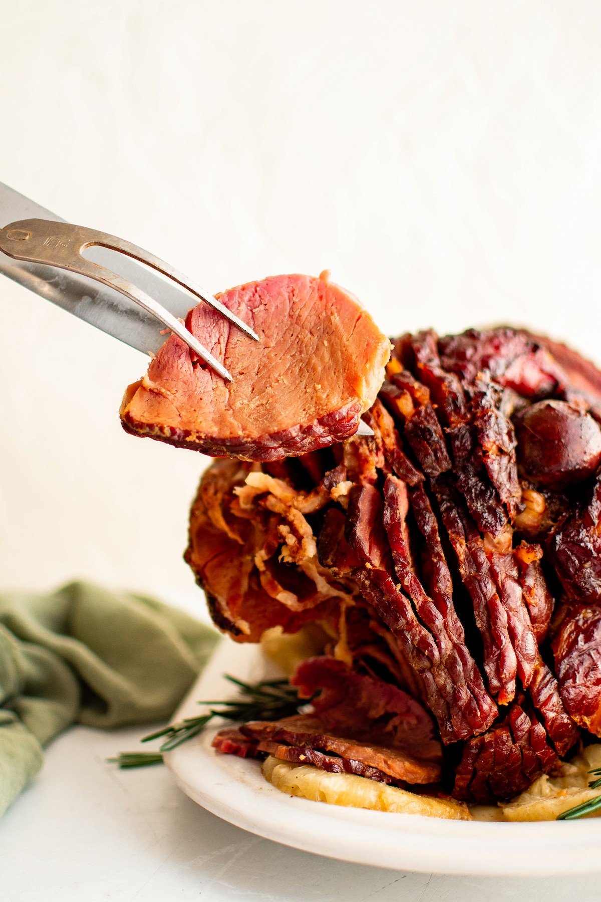 Save oven space with this easy crockpot ham recipe, slow-cooked to juicy perfection in a quick homemade brown sugar and pineapple glaze. Small slice of ham coated in a brown-sugar-pineapple glaze.