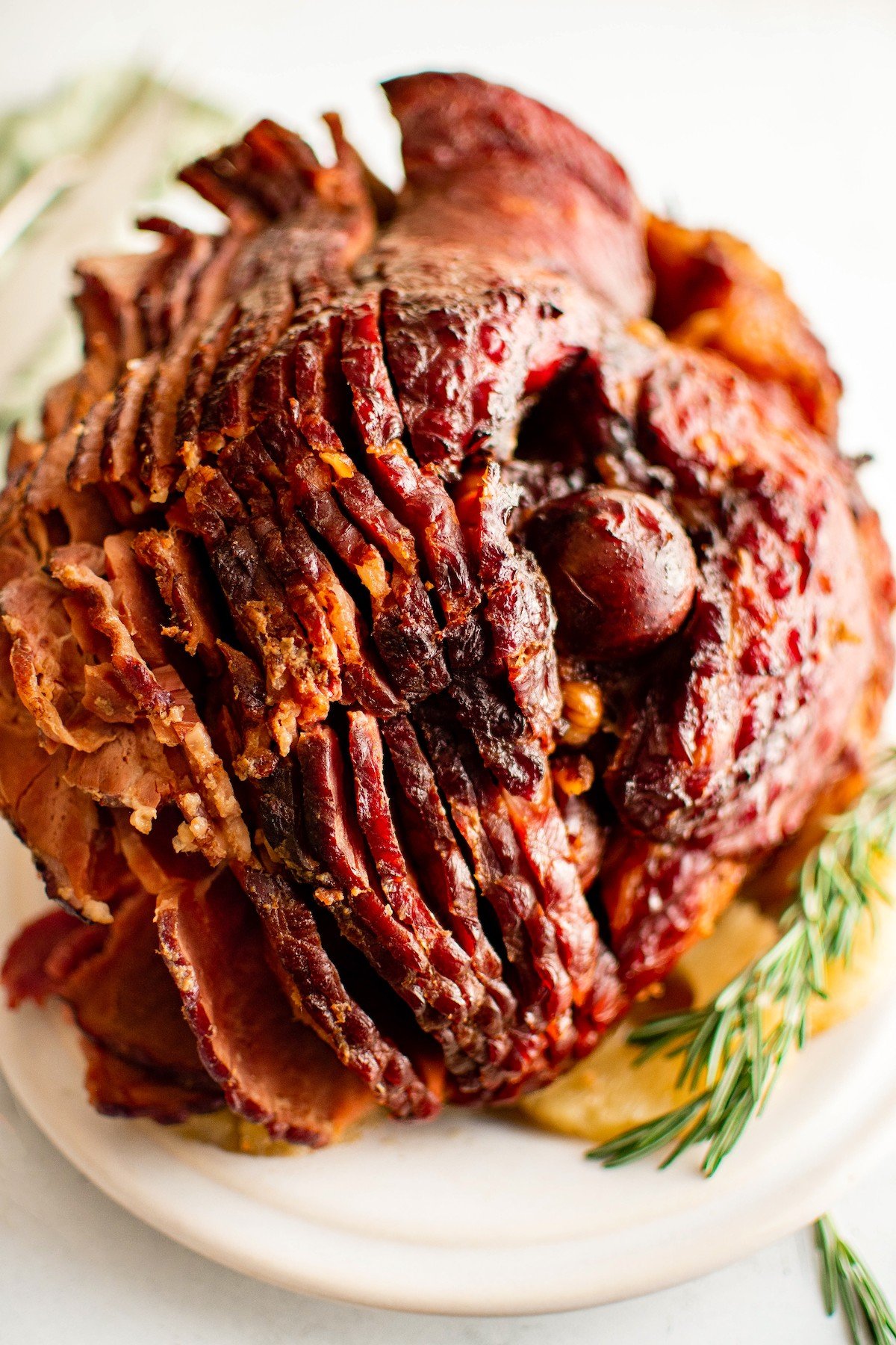 Save oven space with this easy crockpot ham recipe, slow-cooked to juicy perfection in a quick homemade brown sugar and pineapple glaze. Crockpot ham recipe sliced on a platter.