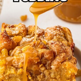 Rum sauce being drizzled over a slice of donut bread pudding on a plate.