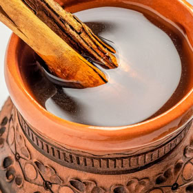 Café de Olla in a mug with a cinnamon stick.