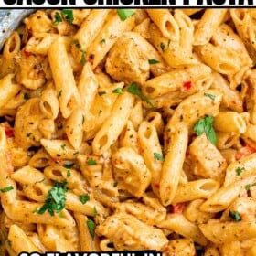 A skillet full of creamy Cajun Chicken Pasta with fresh herbs on top.