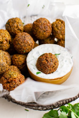 Plate of falafel with a bowl of dip.