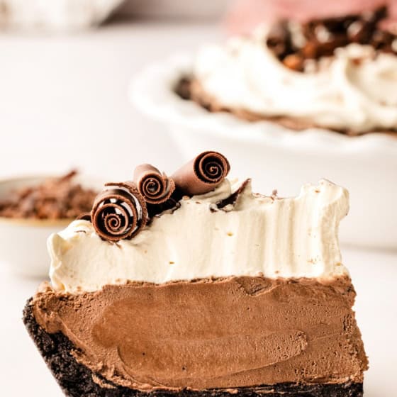 A thick slice of French silk pie is presented on a round plate.