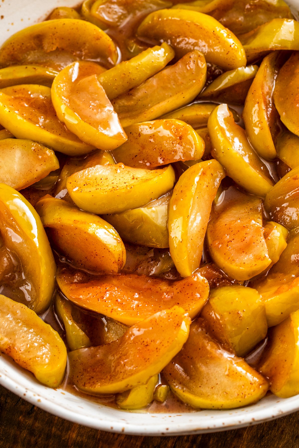 This easy, southern-style Cracker Barrel Fried Apples recipe creates the best tender apples in a comforting cinnamon and brown sugar sauce. Fried apples in a sweet cinnamon and brown sugar syrup in a bowl.