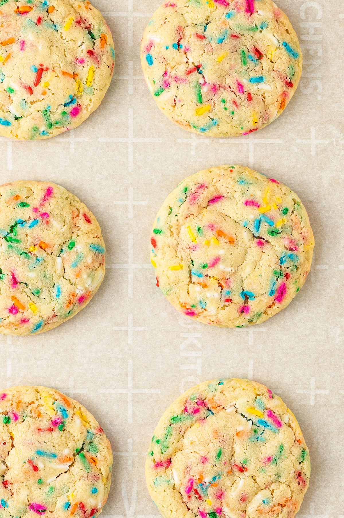 These cute, colorful Funfetti Cookies are soft, sweet, and simple to make. One cheerful sprinkle cookie just isn’t enough! Close-up shot of cookies on a baking sheet.