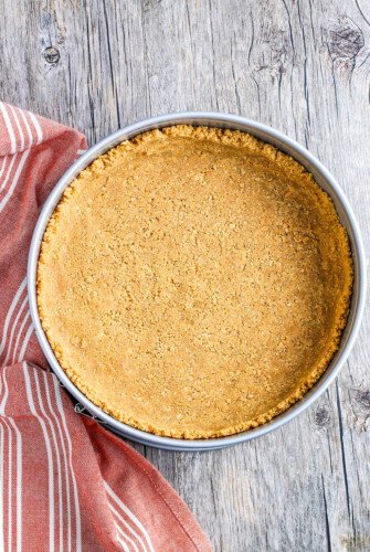 Graham cracker crust in a pan.
