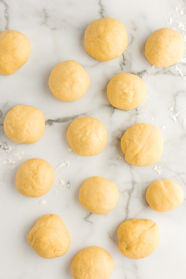 Soft & buttery Hawaiian Rolls are golden in color with a sweet hint of pineapple flavor. This homemade yeast roll recipe is a crowd favorite! Yeast dough formed into round balls.