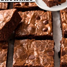 Brownies with glossy, cracked tops are cut into squares.