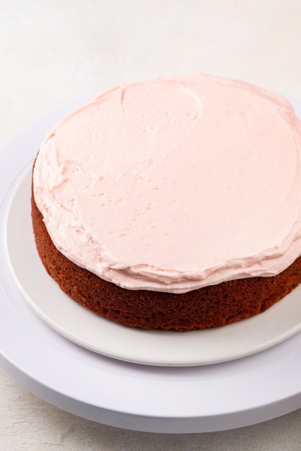 With a soft, tender crumb, this Homemade Strawberry Cake is made entirely from scratch with fresh berries and a creamy strawberry frosting! A single strawberry cake layer has been frosted with strawberry buttercream.