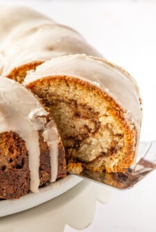 Lifting a slice of cake from a cake stand.