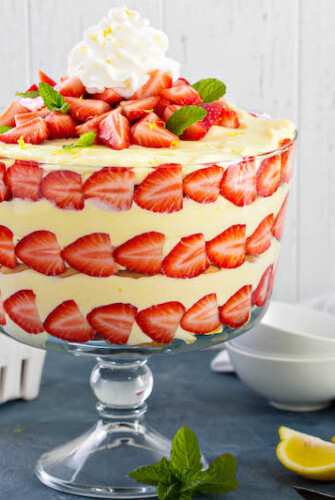 Large trifle bowl filled with lemon strawberry pudding trifle