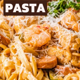 A bowl of pasta with cajun chicken, sausage and shrimp.