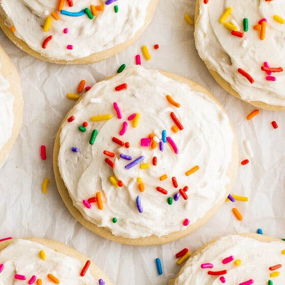 Close-up shot of frosted sugar cookies decorated with sprinkles.