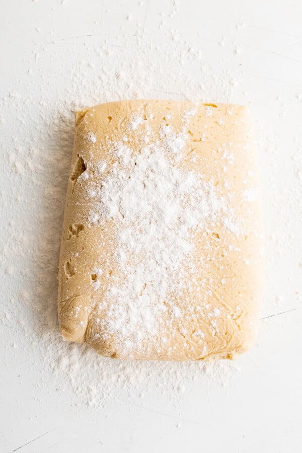 A rectangle of chilled cookie dough on a work surface.