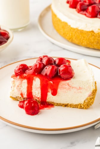 A slice of cherry cheesecake on a plate.