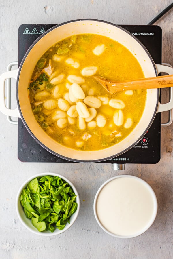 Gnocchi cooking in chicken broth.