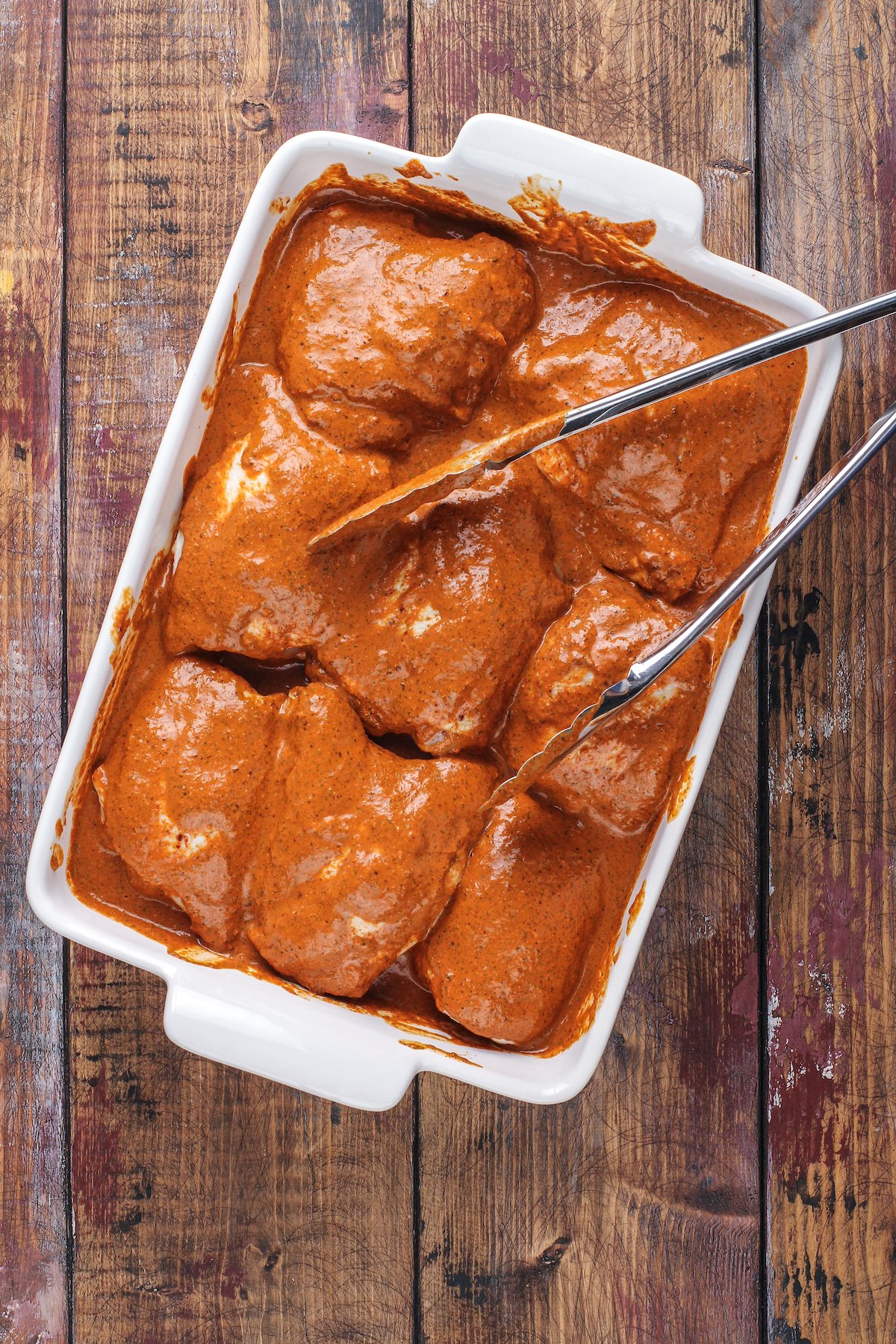 This juicy Mexican pollo asado is tangy, sweet, and smoky. Loaded with orange juice and cumin, it's then grilled to tender perfection. Marinating the chicken in a baking dish.