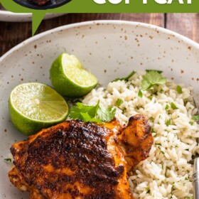 Polo asado over a bed of rice on a plate with lime wedges and cilantro.