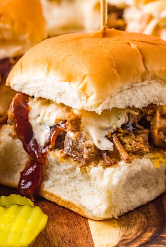 A pork sandwich on a small bun.