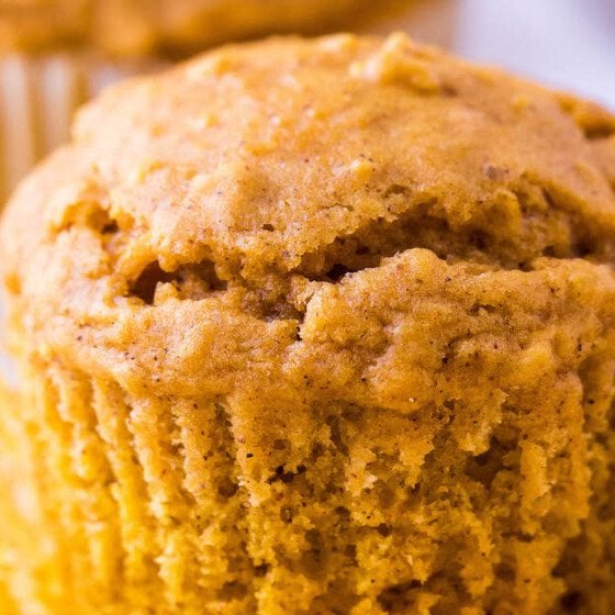 Up close image of a pumpkin oatmeal muffin with liner pulled down.