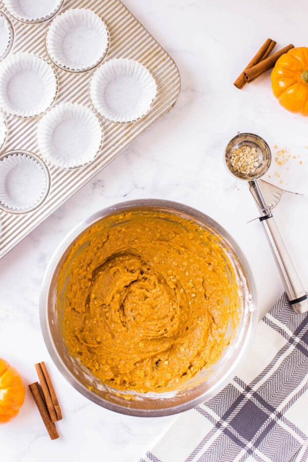 These Pumpkin Oatmeal Muffins are made easily in just one-bowl and are loaded with pumpkin flavor with a deliciously chewy consistency! Pumpkin oat muffin batter in a bowl.