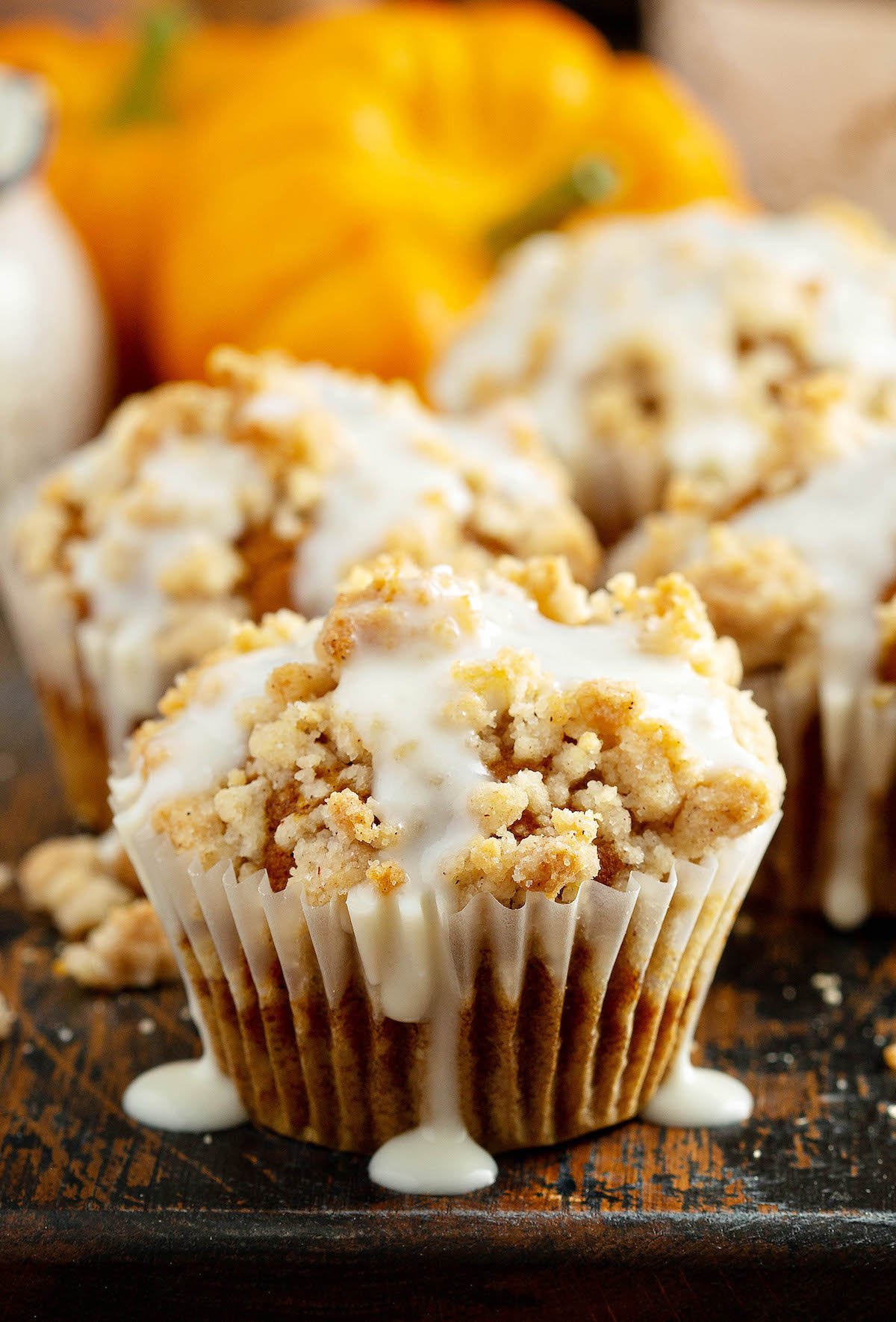 Moist, pumpkin streusel muffins are perfectly spiced with a crumbly cinnamon streusel topping and an optional drizzle of cream cheese icing! Pumpkin streusel muffin drizzled with cream cheese icing.
