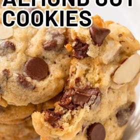 A bite has been taken out of a soft and chewy almond joy cookie.