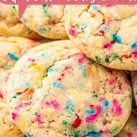 Sprinkle sugar cookies stacked on top of each other on a plate.