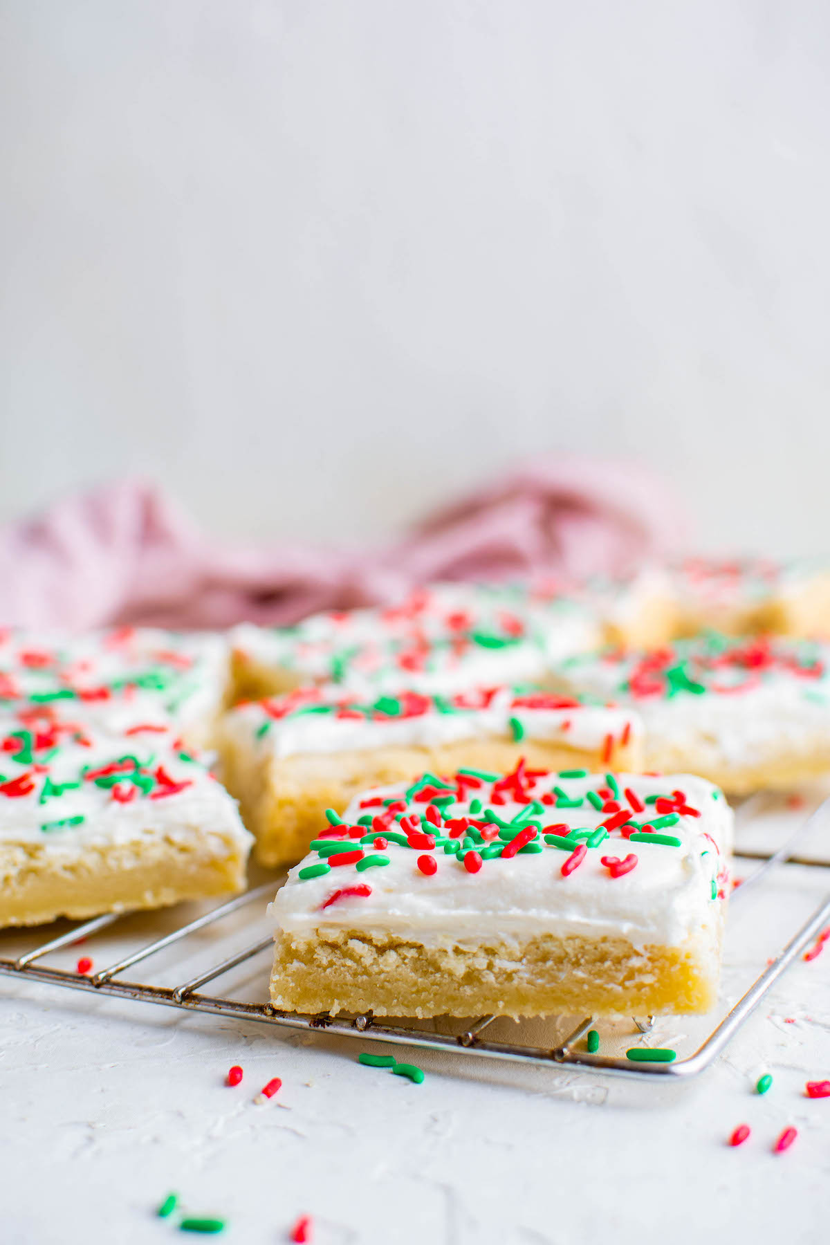 Sugar cookie bars on a cookie cooling rack.